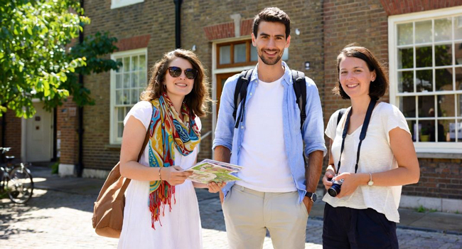  Adultes participants à un séjour linguistique LISA! à Cambridge City Angleterre avec une carte explorent la région ensemble