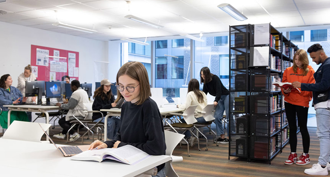  Adultes étudiant l’anglais à Londres Angleterre lors d’un séjour linguistique LISA! dans une bibliothèque moderne avec ordinateurs